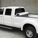 White pickup with a 55 gallon Vector fuel transfer tank in the back