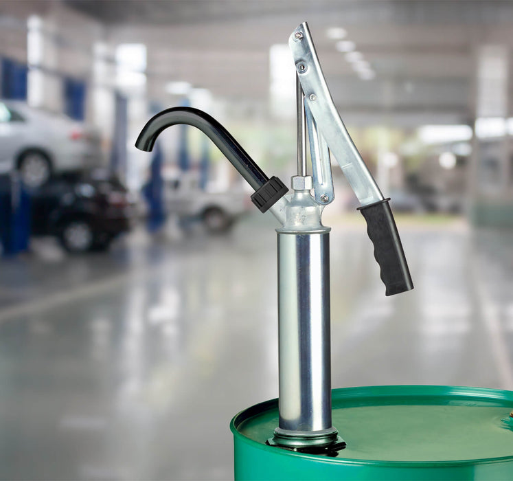 GPI BP-12 lever action steel hand pump mounted to a barrel in a garage