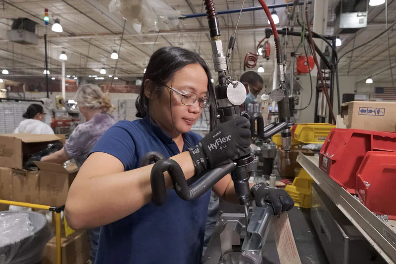 Person working with equipment in a factory setting