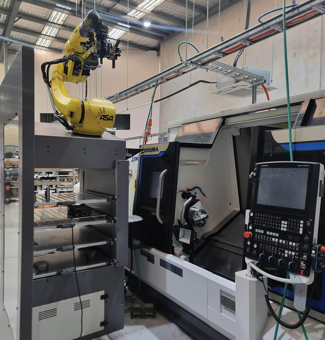 Robotic arm in a manufacturing setting with industrial equipment.