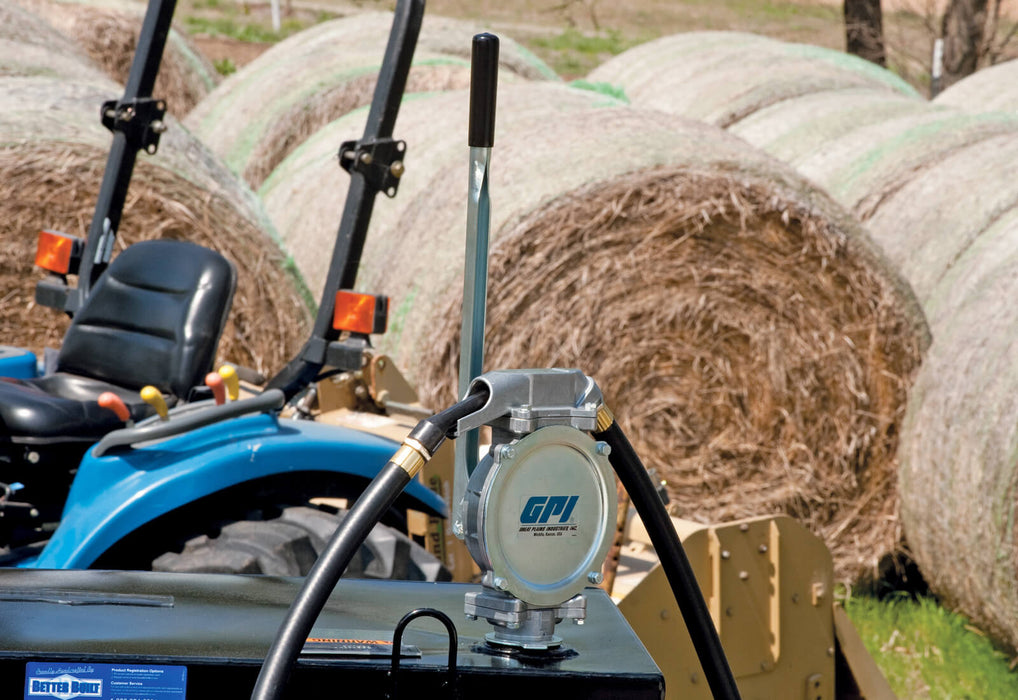 GPI DP-20 UL hand pump mounted to a tank in front of a tractor and round bales