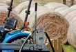 GPI DP-20 UL hand pump mounted to a tank in front of a tractor and round bales